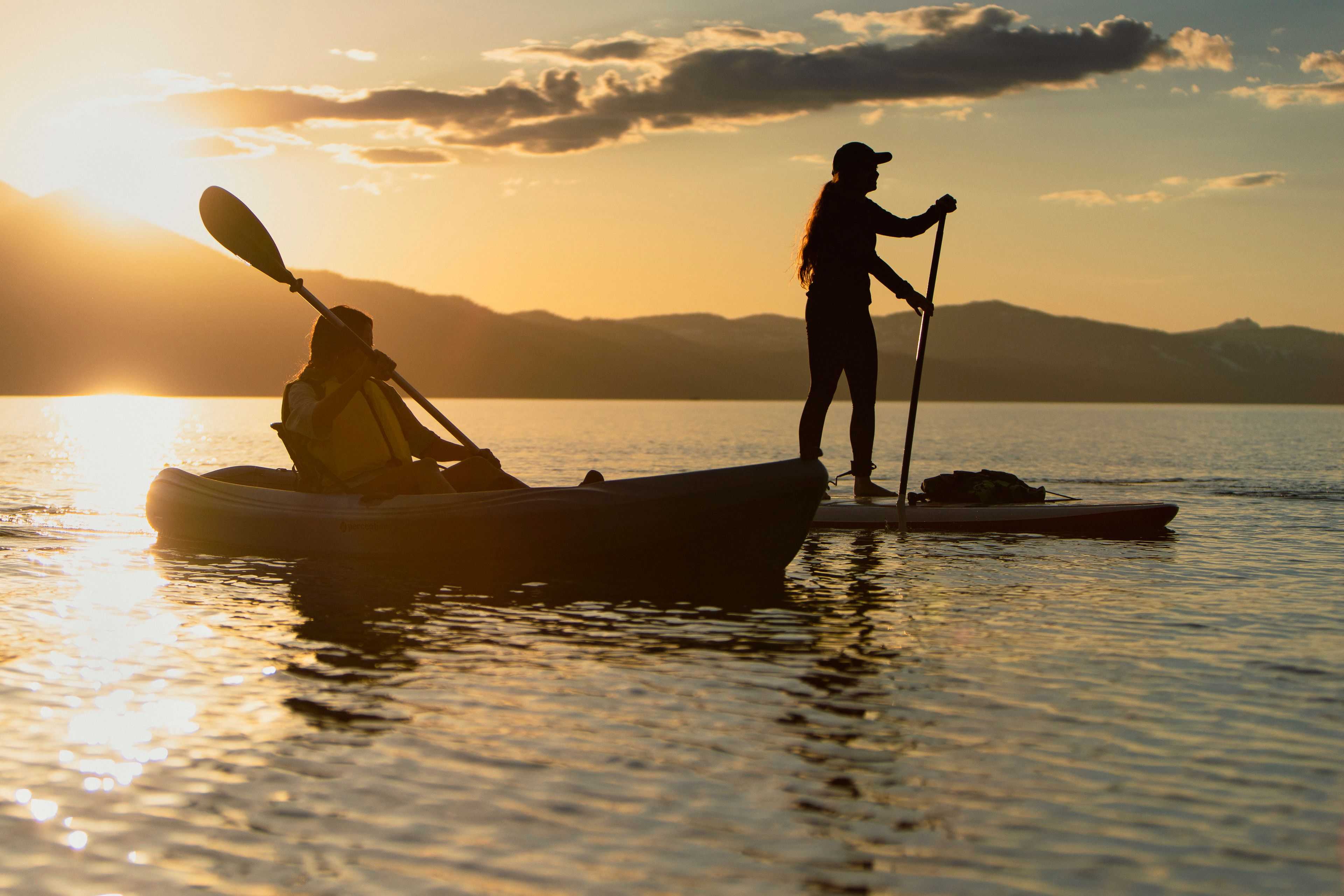 kayaker and paddle boarder on Lake Tahoe at sunset