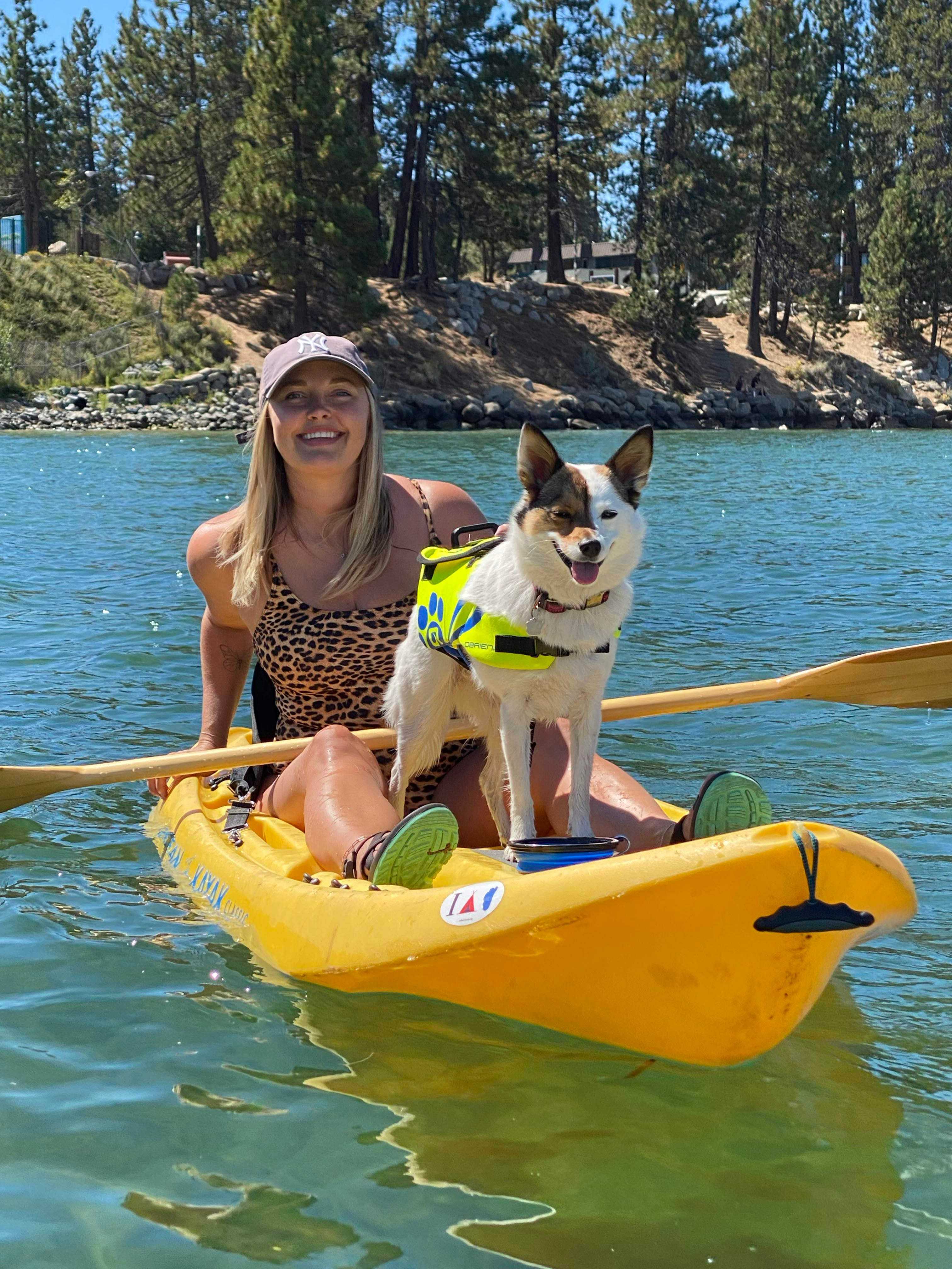 kayak guide on the lake with her dog
